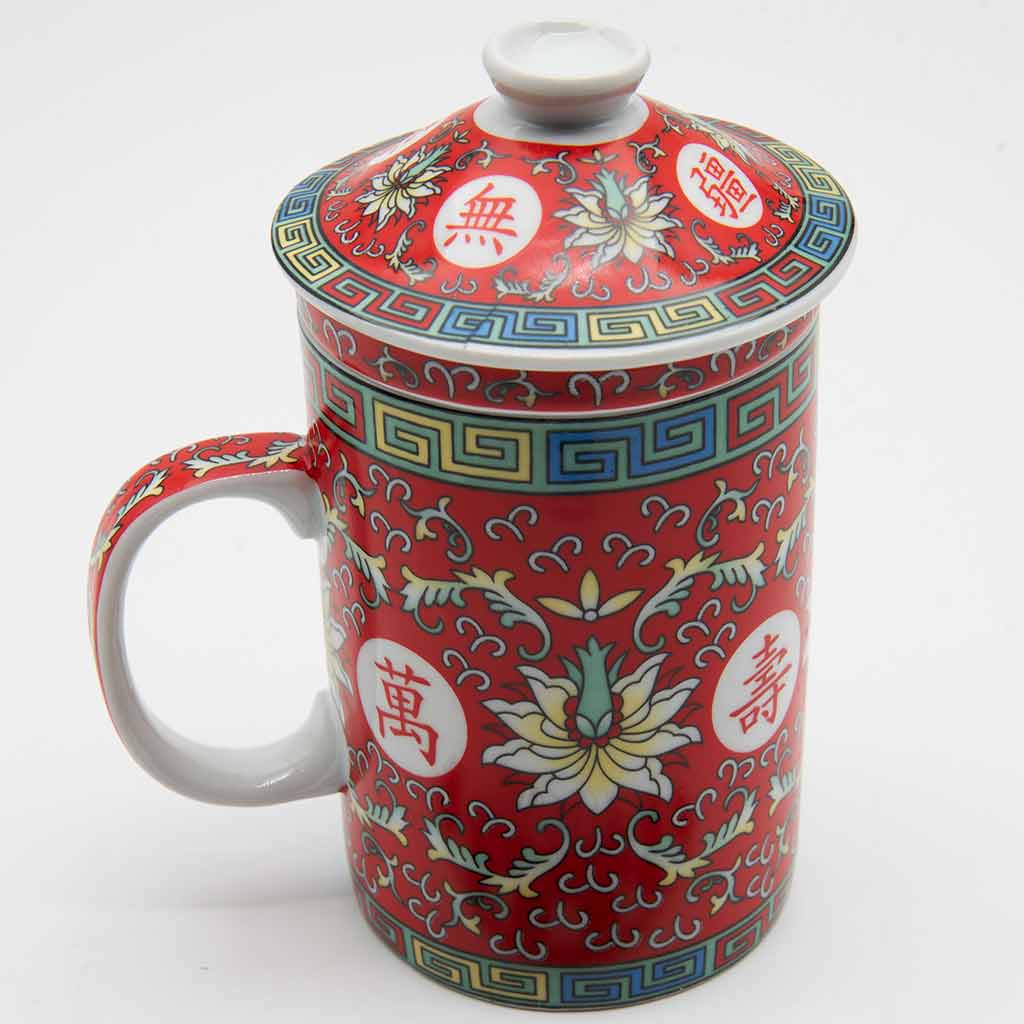 a red porcelain cup and lid with floral designs