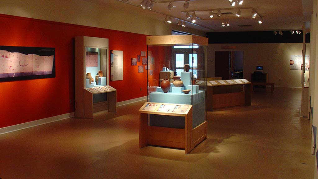 left side view of the gallery with the display case of pots as the focus