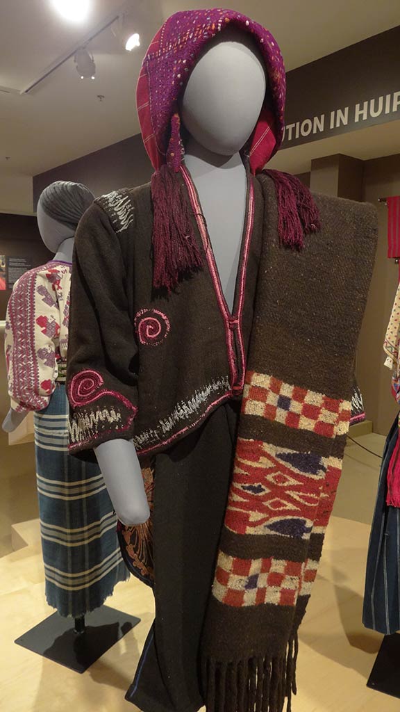 traditional maya clothes, brown body and scarf with a purple and red hood
