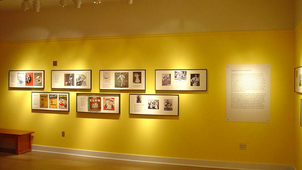 photos of calypso hung on the yellow wall