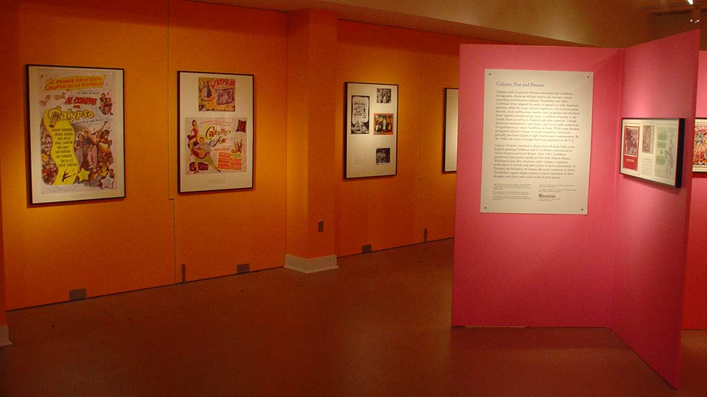 photos of calypso hung on the orange and pink walls