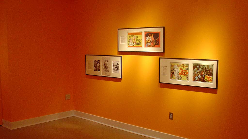 photos of calypso hung on the orange wall