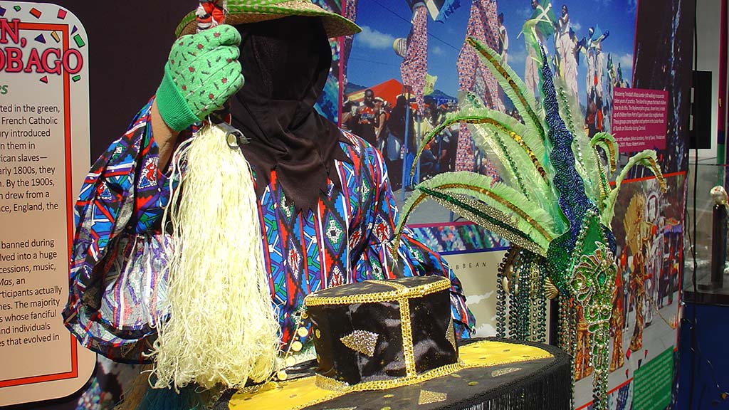 feather headdress, and a model holding up something that looks like a mop