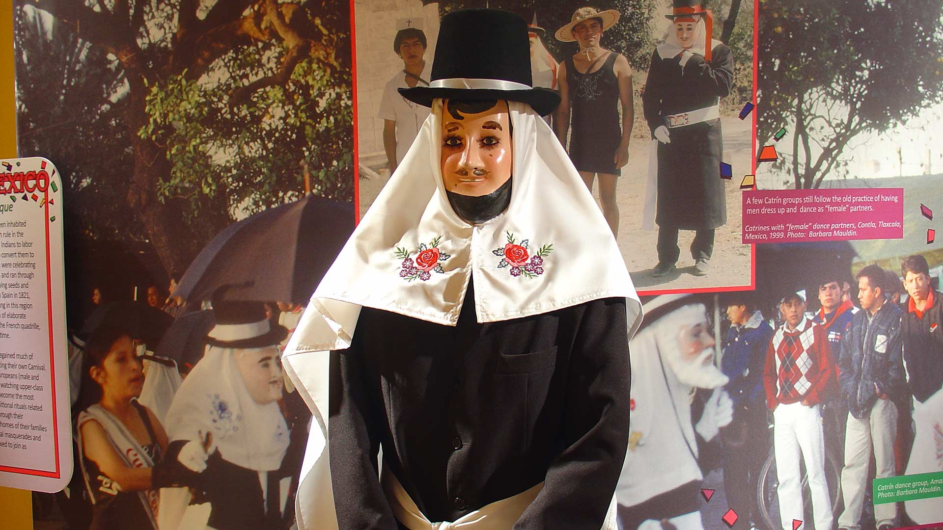 man dress in black, wearing black hat and white head covering