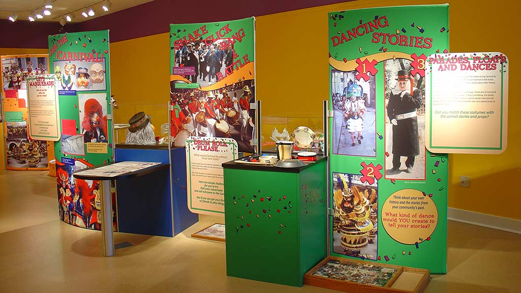 front view, three display stands of the same text panels and objects