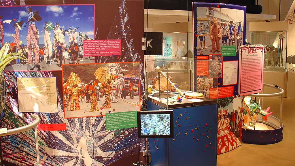 men wearing head masks, display stands, colorful photos and posters on the background