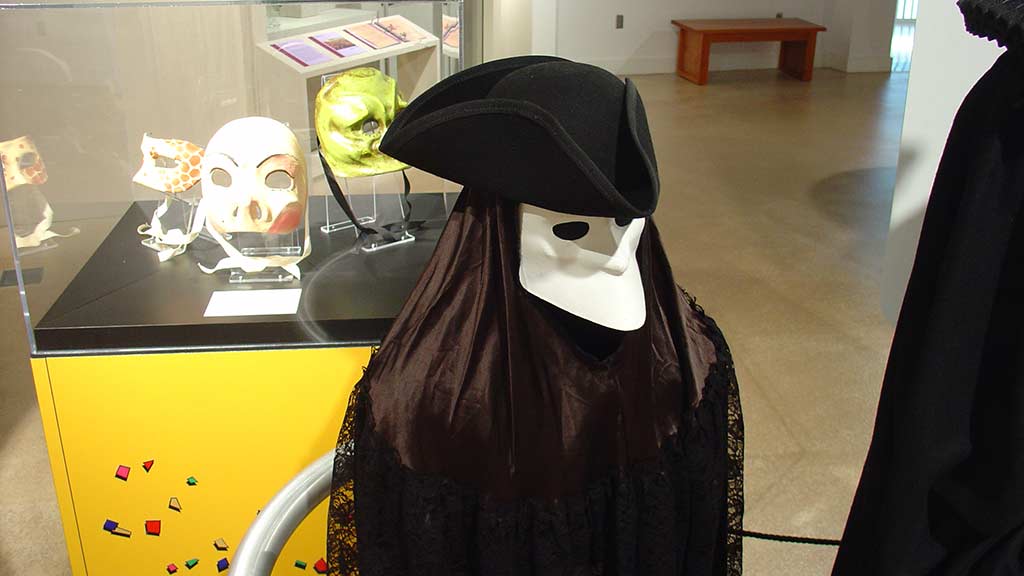 god of the death dressed in black wearing a white mask