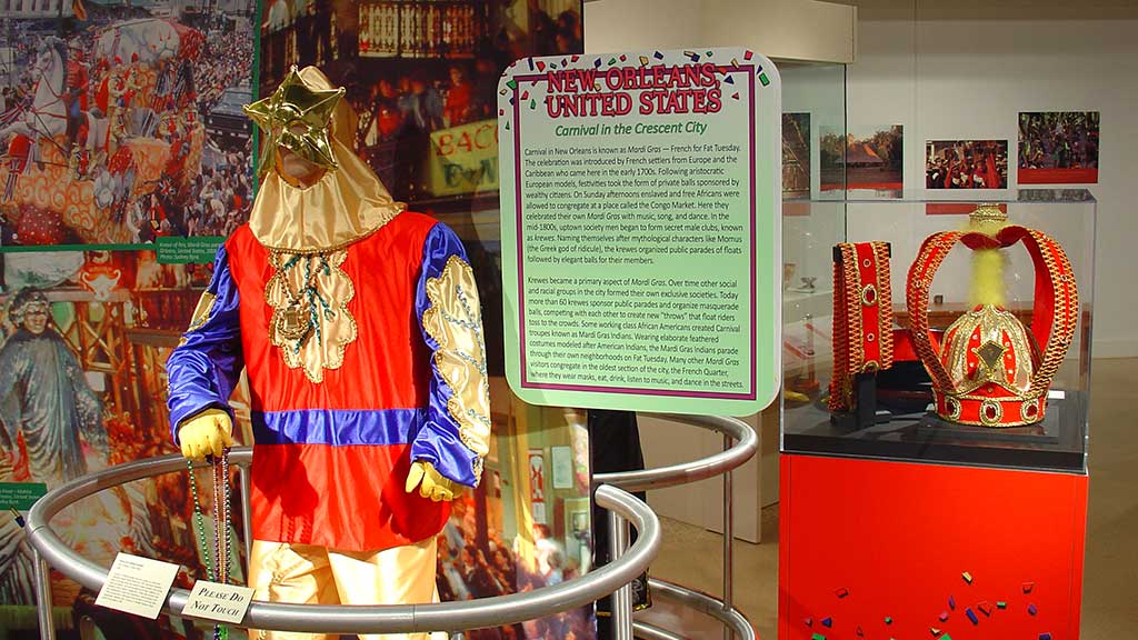 man wearing gold masks and dress in purple, red and gold