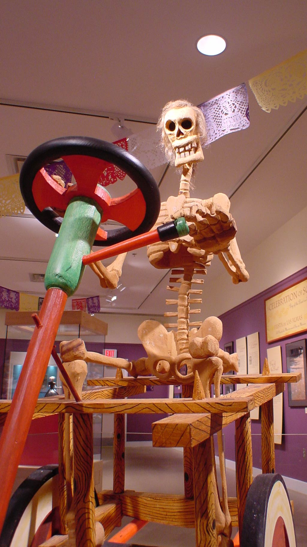 skeleton driving two wheel wooden vehicle