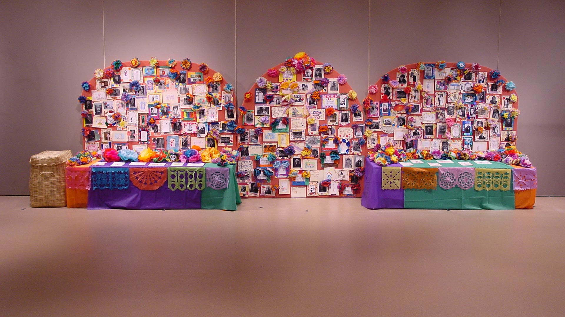 photos and flowers with decorative tables sitting below them