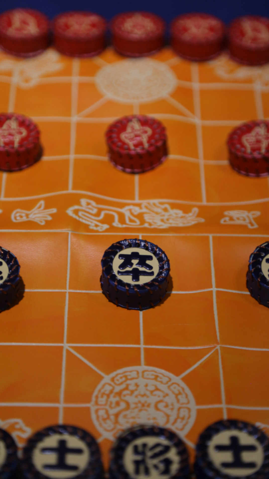 a closeup shot of blue and red circular pieces from another chess-like game