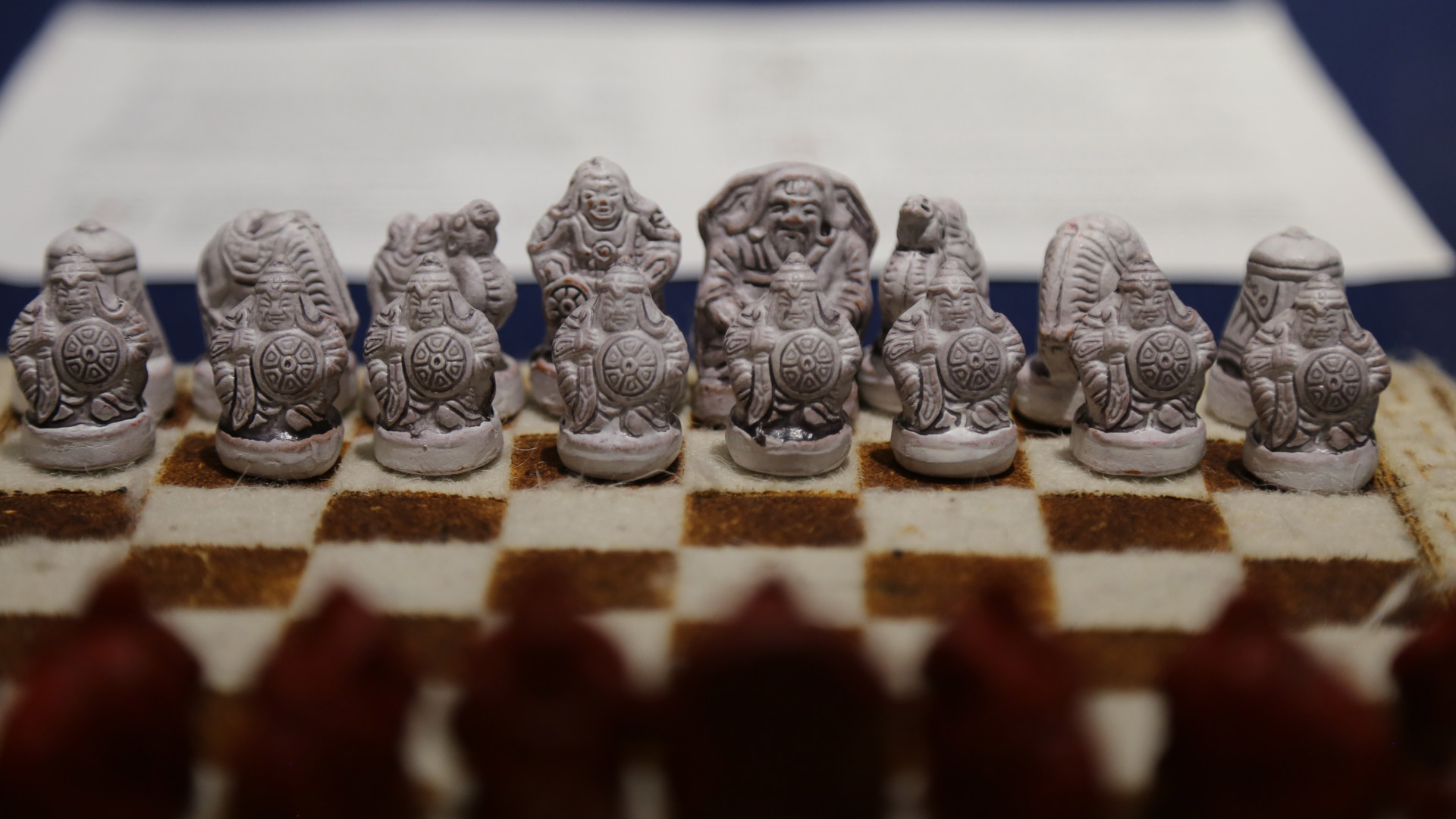 a closeup shot of what appears to be stone-like chess pieces based on mythology
