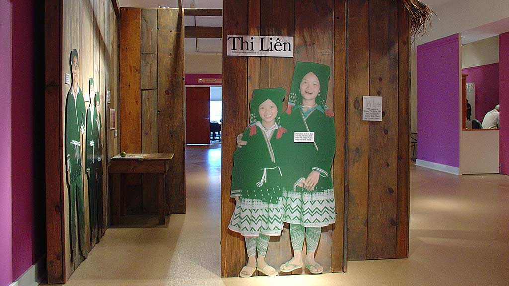 children in Thi Lien section, wearing clothes that looks like school uniform with one hugging the other