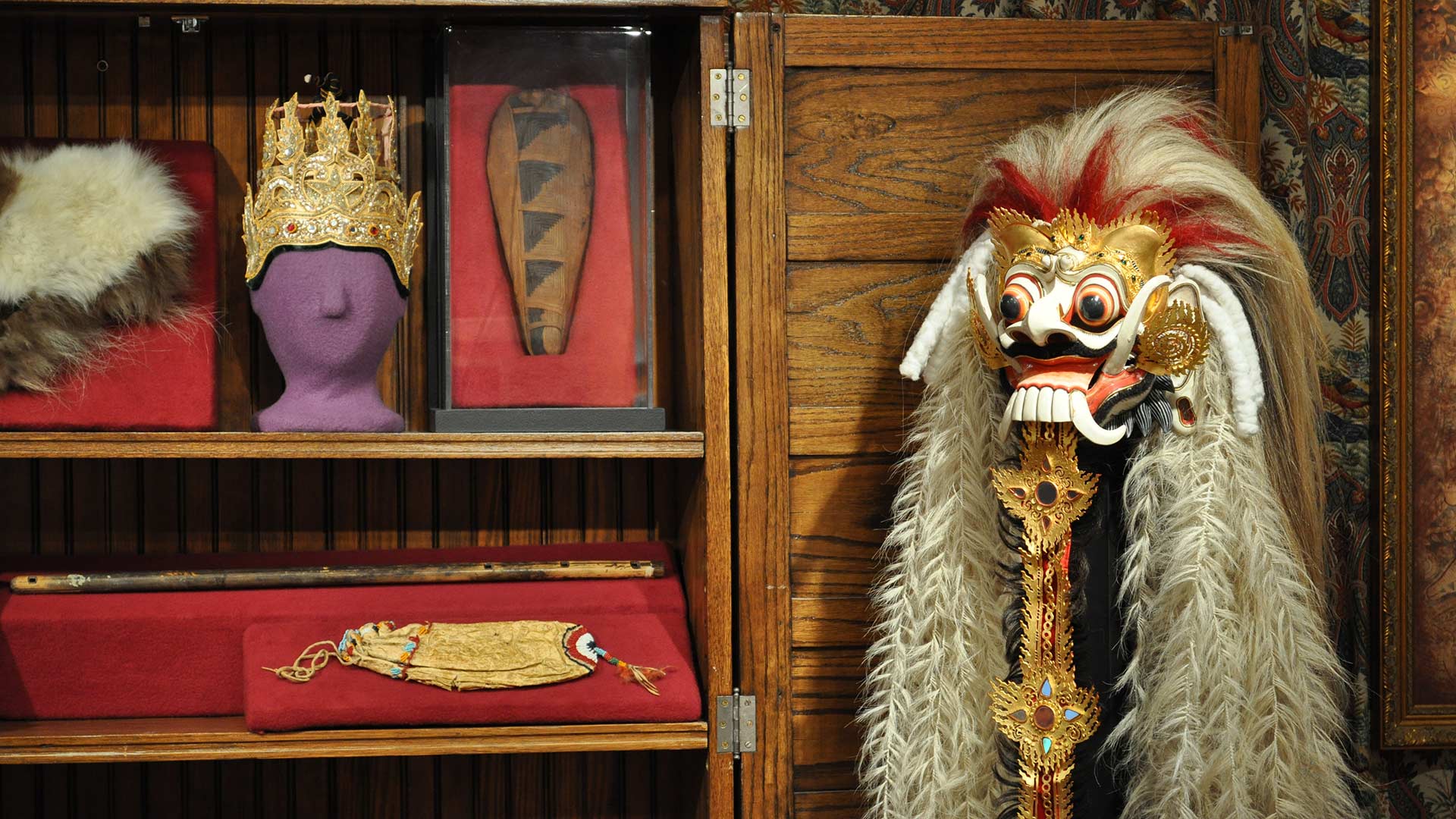 head mask, crown, fur, wooden object and fringe