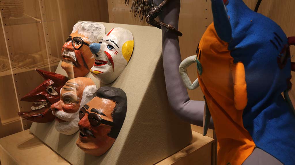 mannequin holding whip and masks