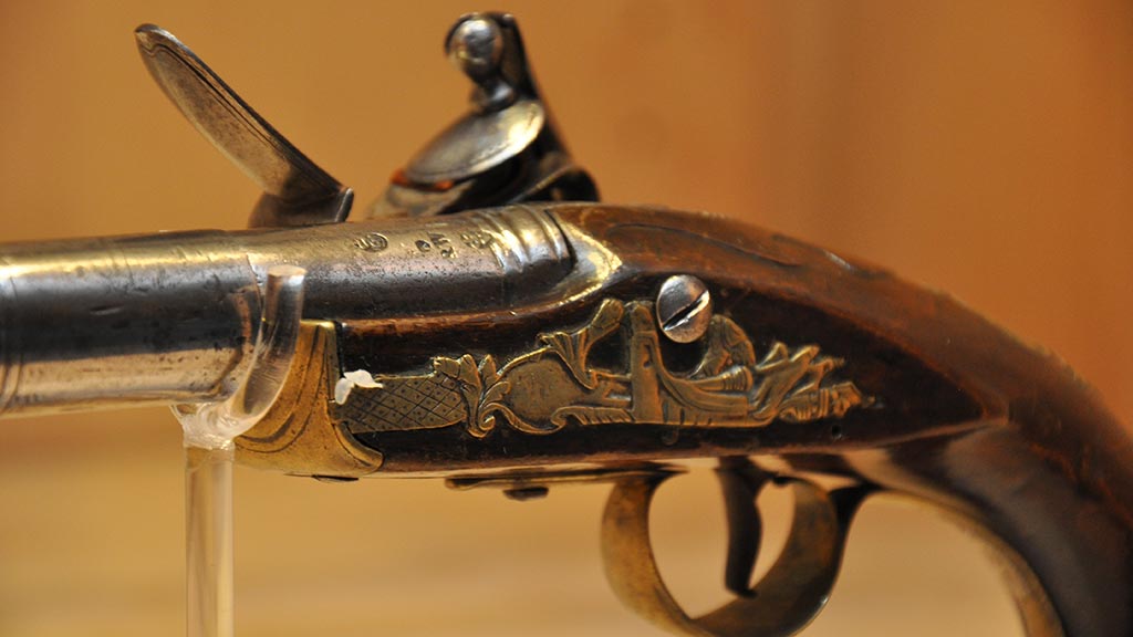decorated thumb plate on top of the handle