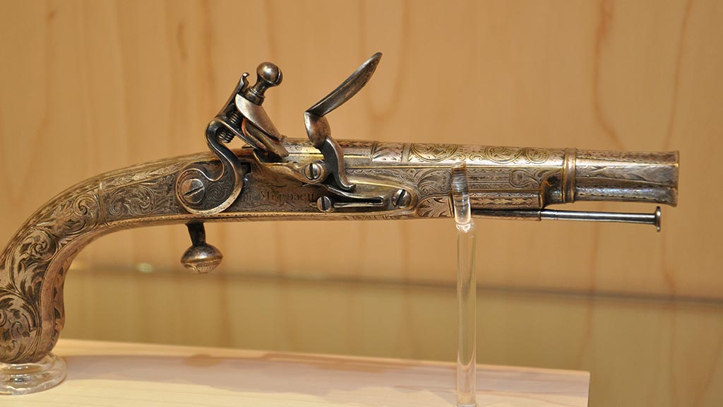 light goldenrod yellow gun decorated with a sculpted figure