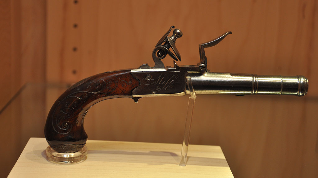 red maple color gun decorated with a sculpted figure