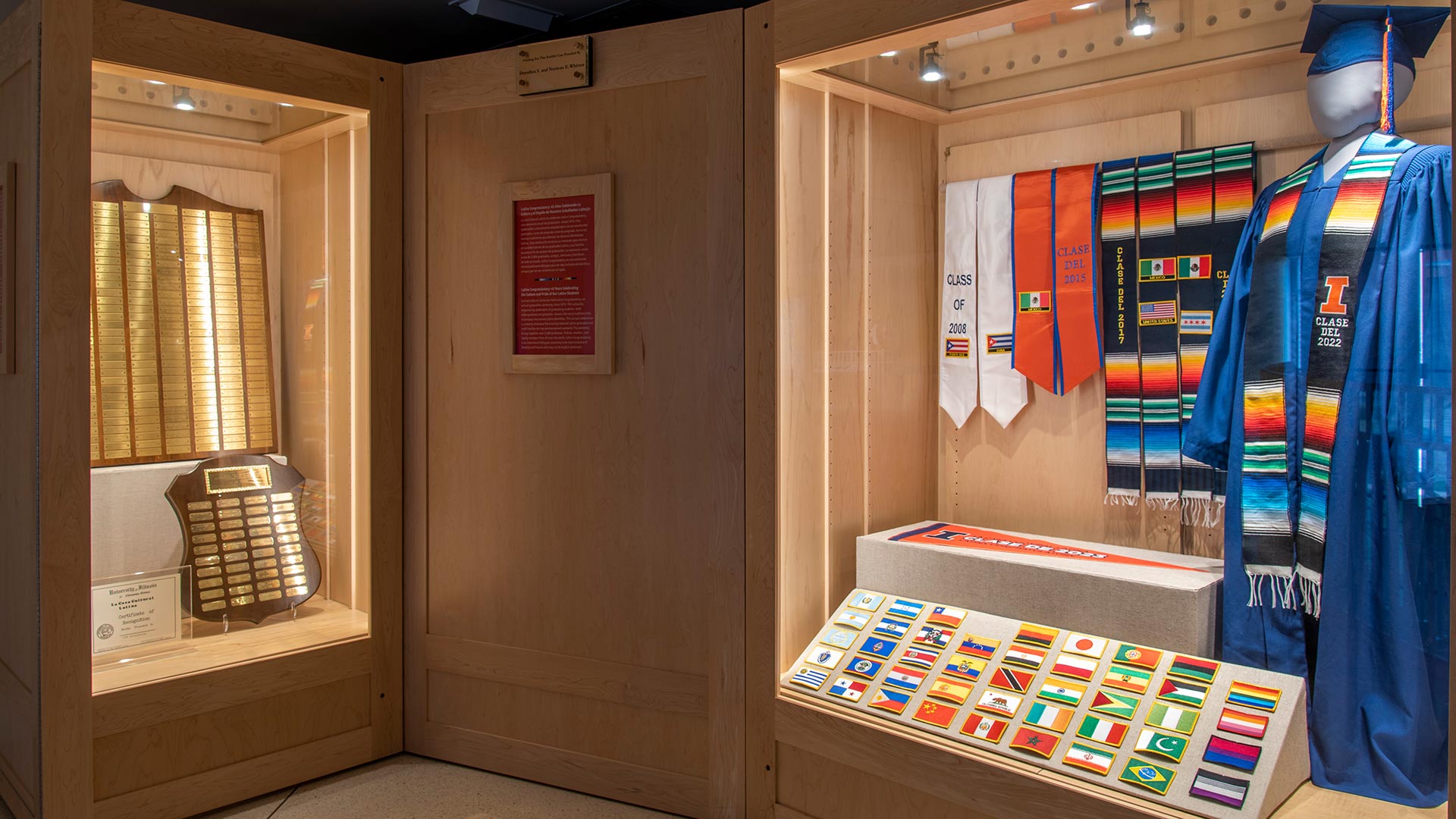 two display cases in front of wall of framed artifacts