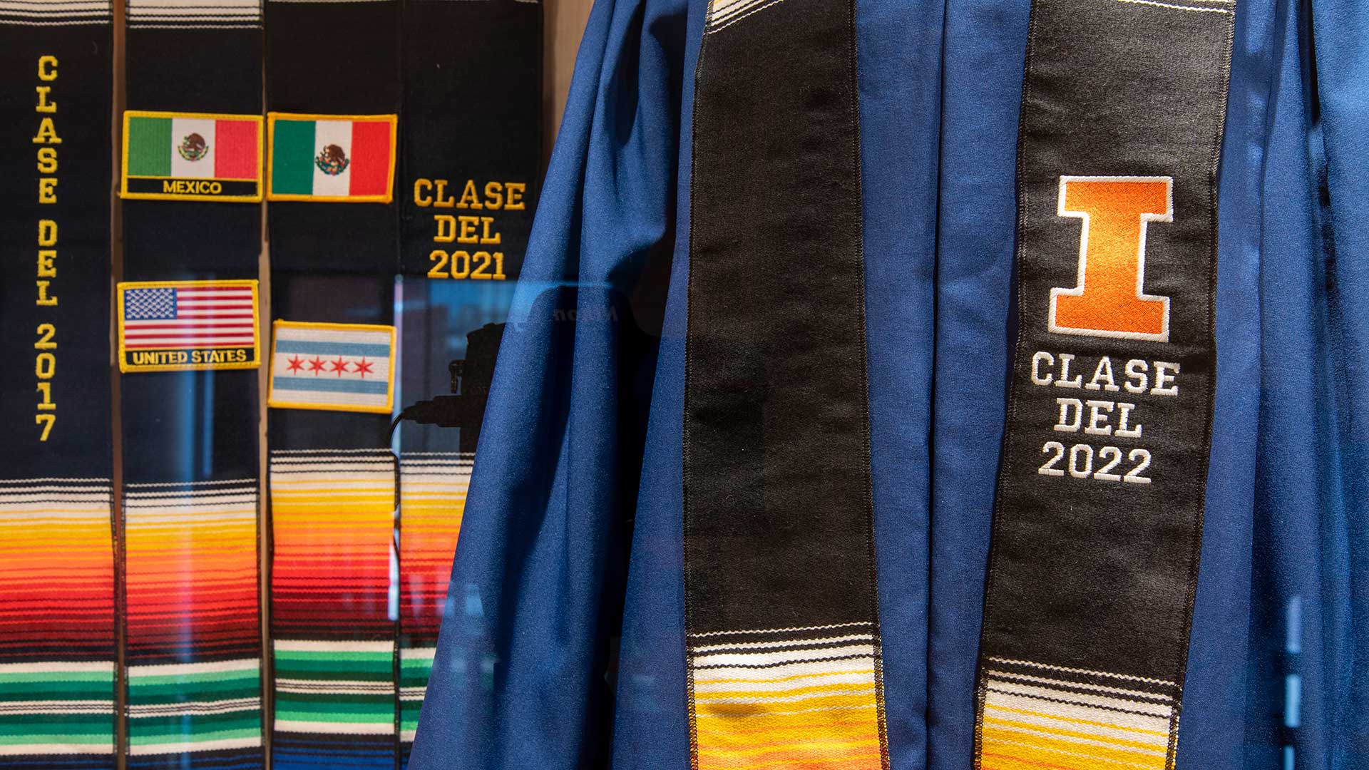 Close up image of graduation regalia and Latinx stoles