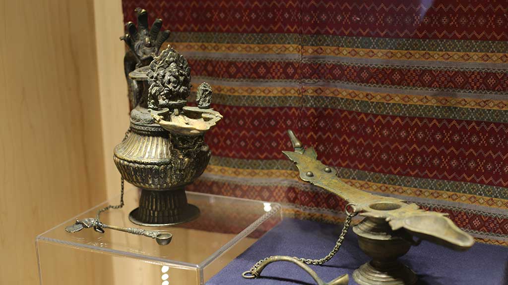 metal sculptures in front of a backdrop of a red cloth