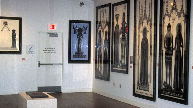 closeup of collection of brass rubbings hung on the wall