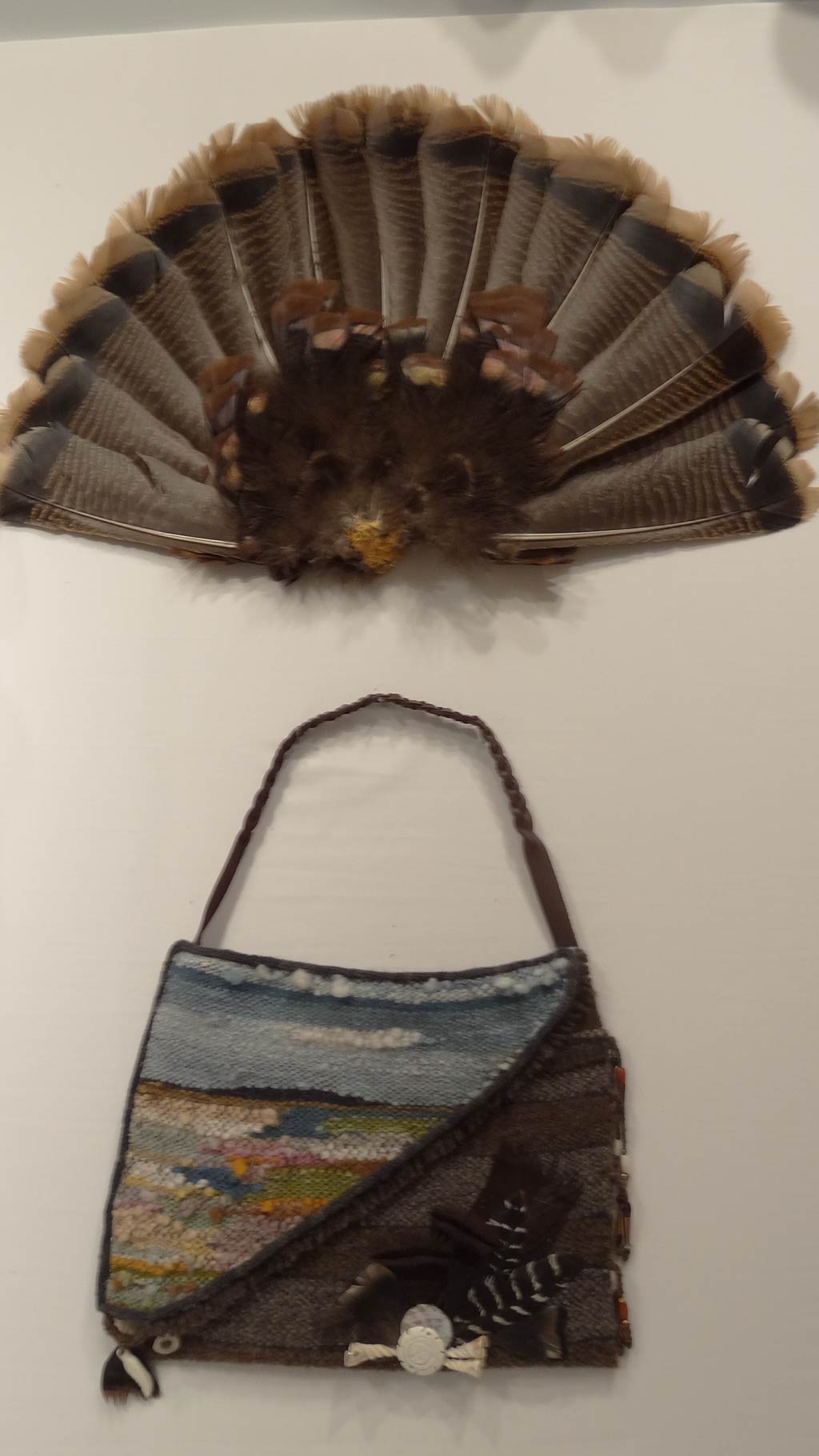 a feather fan and bag