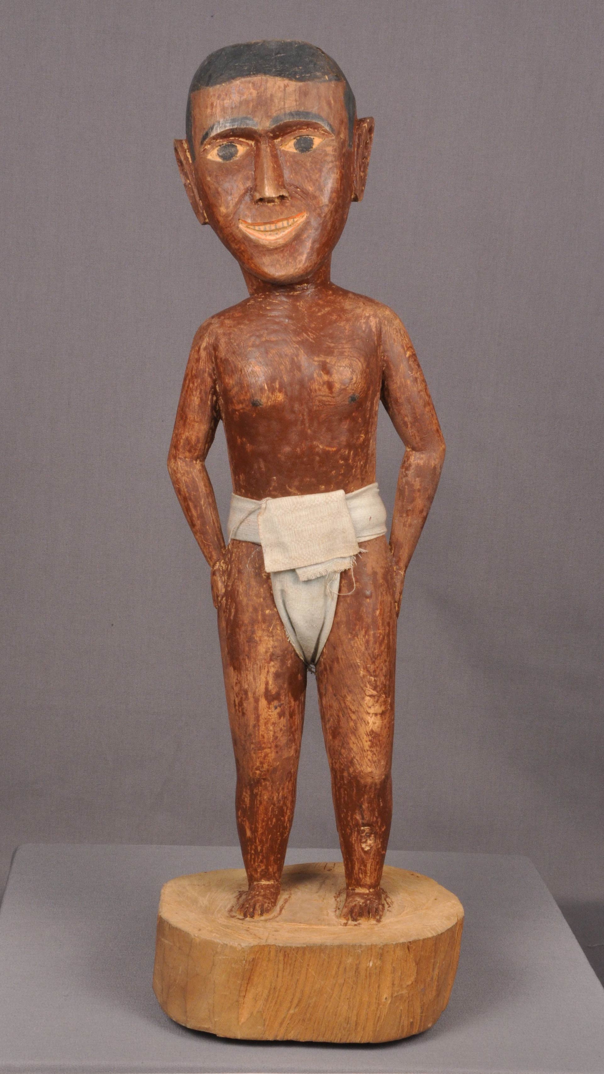 wooden male figure that is smiling