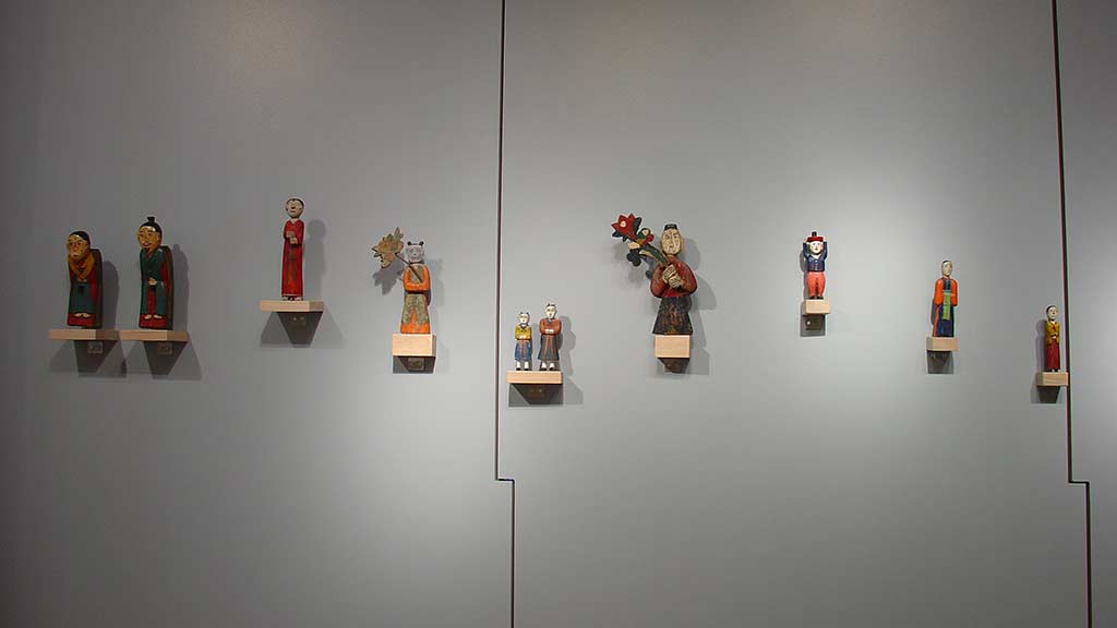 many figurines line on a wall