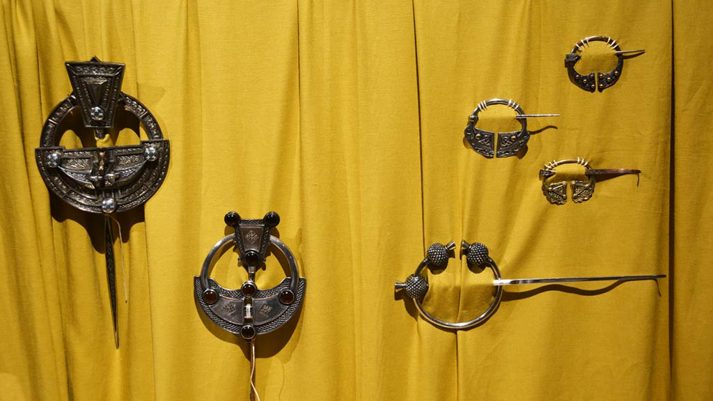 Tara Brooch on mustard yellow fabric