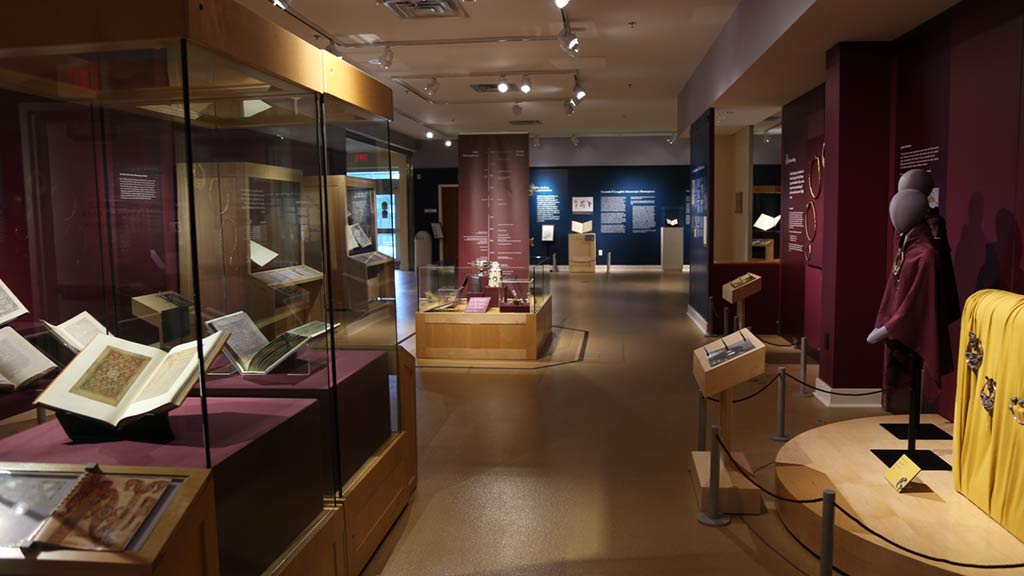 gallery view, red and blue walls that show many of the objects on display