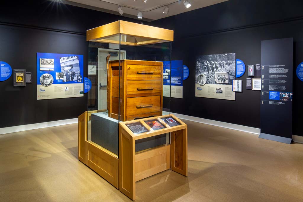 wooden chest of drawers in a display case