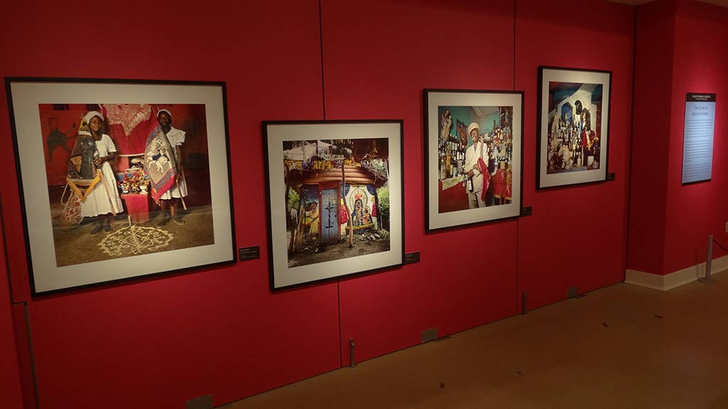 portraits framed on the red wall