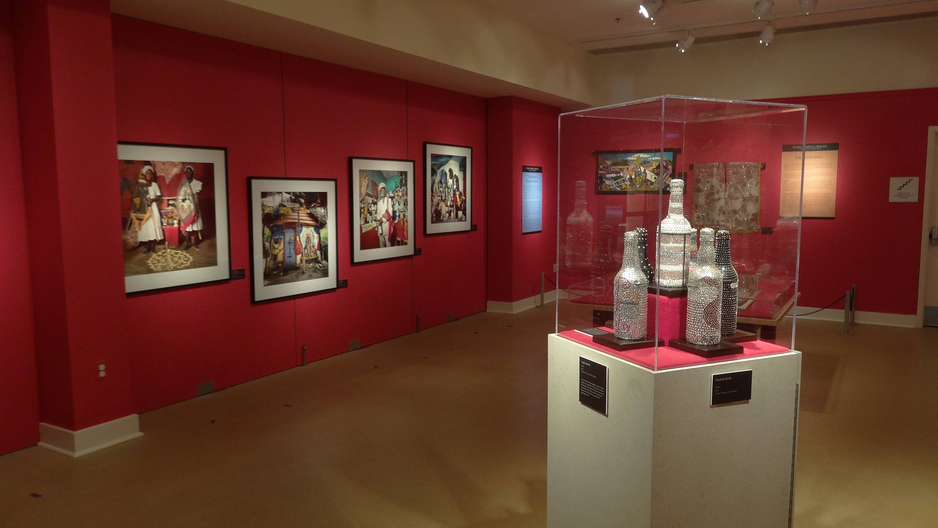 postraits on the wall, artifacts that look like bottles in the display case