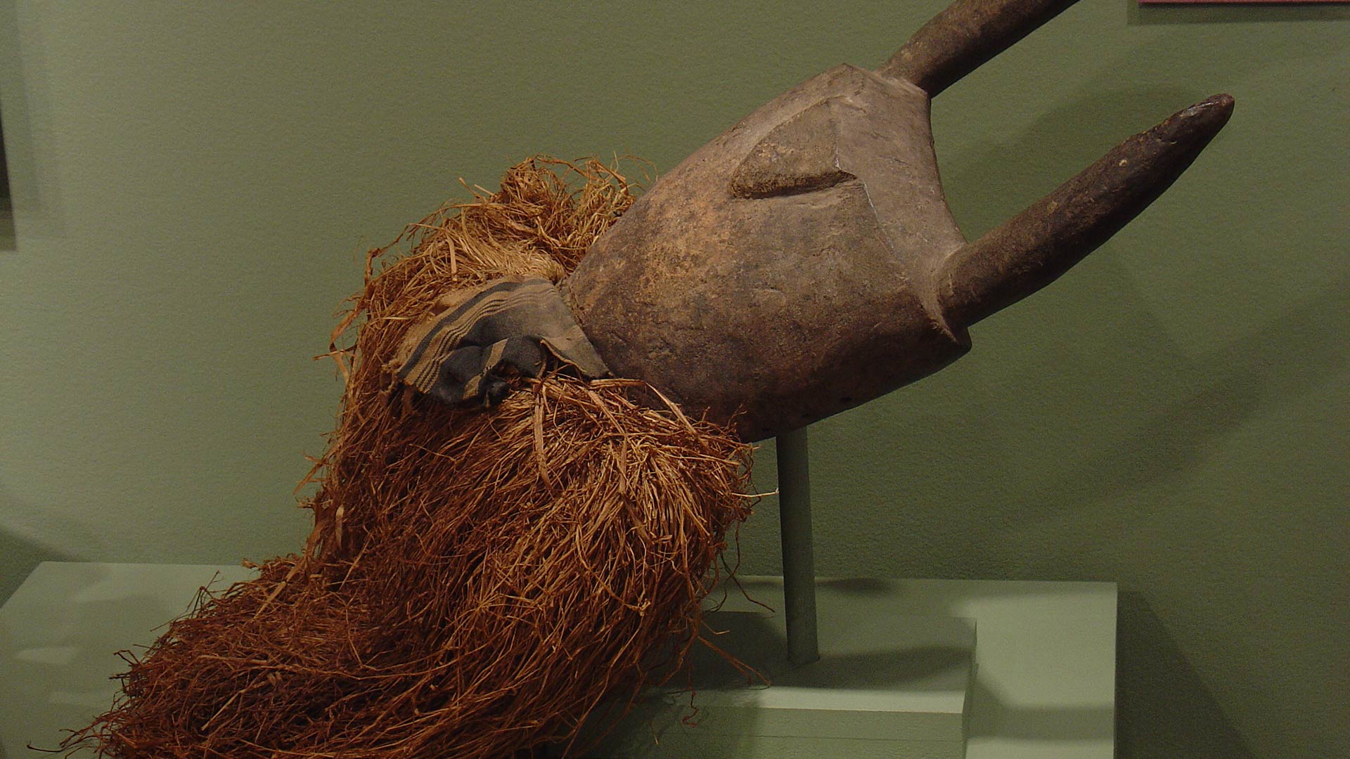wooden mask with fringe