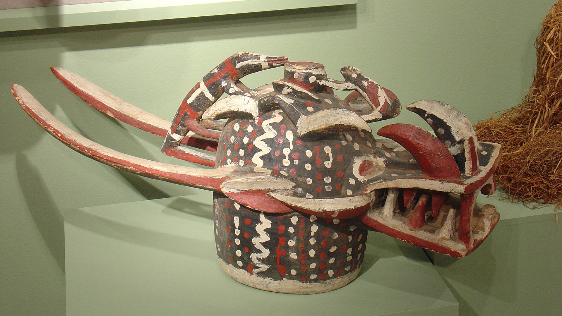 ceramic, cream, red and black model of an animal