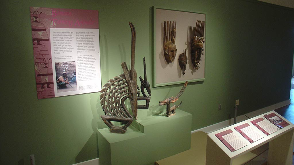 wooden sculptures of two animals, one large and one small
