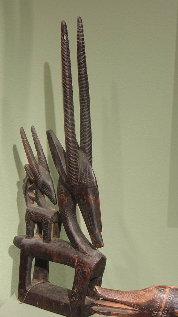 wooden sculpture of a small goat on a large goat