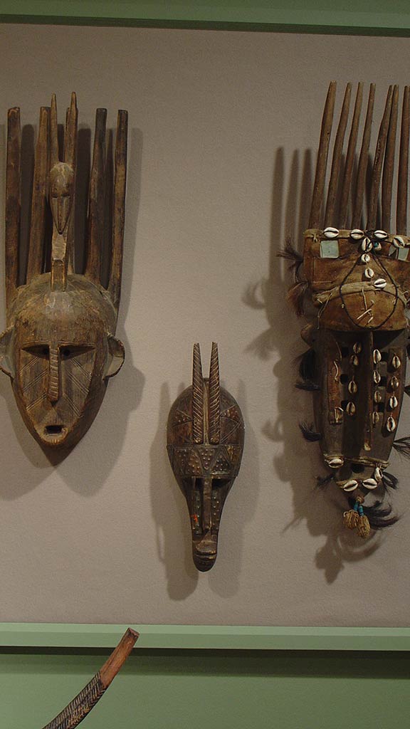 three wooden masks varying in size